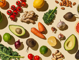 Pattern of variety fresh of organic fruits and vegetables and healthy vegan meal ingredients on beige background.