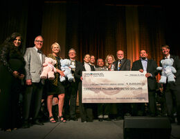 hospital administrators and san manuel tribe representatives stand with check