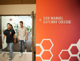 San Manuel Gateway College is located at LLUH - San Bernardino Campus College interior signage with students walking by