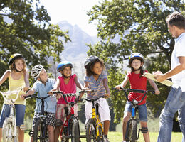 Children Having Bicycle Safety Lesson From Adult
