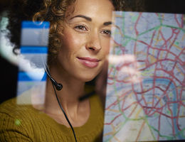 A woman looks happy while viewing an online map