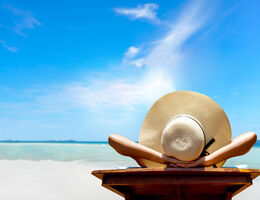 Woman sitting in chair with hat on