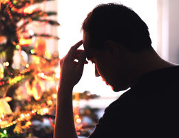 Sad on Christmas. Unhappy, lonely or tired man with stress, grief or depression. Family fight, loneliness, frustration or money problem on Xmas. stock photo