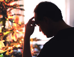 Marriage and family therapist, Stephen Graves, says adults can feel anxious in environments where trauma occurred at a young age. Sad on Christmas. Unhappy, lonely or tired man with stress, grief or depression. Family fight, loneliness, frustration or money problem on Xmas. stock photo