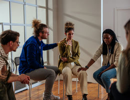 People attending self help therapy group meeting in community center stock photo