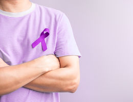 Man wearing purple ribbon for testicular cancer awareness