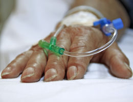 Close up shot of IV in older person's hand