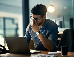 Stock image of young man stressed at work