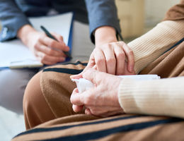 Clinician holding hand of elderly patient