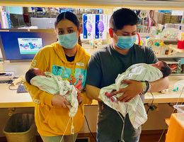 Violeta Andrade and her boyfriend, Marco Benitez, hold their newborn twins in the neonatal intensive care unit of the LLU Medical Center.