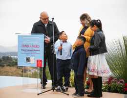 hispanic family stands together by glass podium