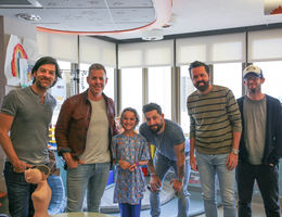 five members of country band poses with young female patient