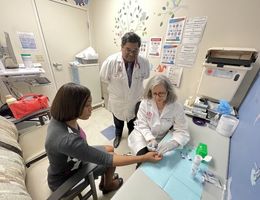 Doctors in a clinic room screening a patient for sickle cell disease