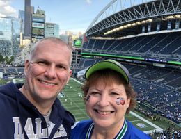 From left: Ed Koehn and his wife, Karen, take a selfie in a Seattle stadium to watch their favorite football teams — Cowboys and Seahawks — play in October 2018.