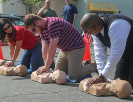 three people learning hands-only CPR