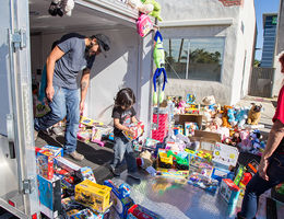 child picks toy from trailer