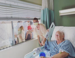 Family visits Jill Burkhart during her hospital stay.