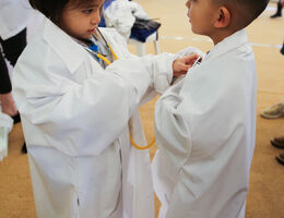 young boy and young girl listen to each other's heart beats