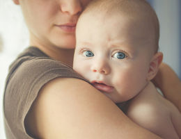 Mom hugs an infant