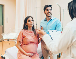 Husband and wife talking to the doctor in the hospital