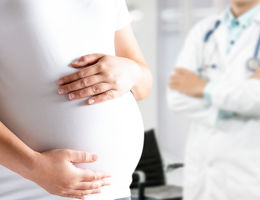 Happy pregnant woman visit gynecologist doctor at hospital or medical clinic for pregnancy consultant.