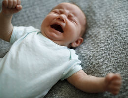 Little baby boy crying with opened mouth 