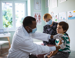 Close up of a pediatrician vaccinating his patient