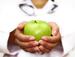 Hands holding an apple