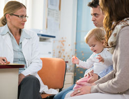 Pediatrician with baby and her Parents