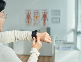 Elderly woman looking at heart rate display on smart watch