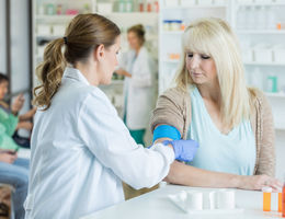 female physician giving flu shot to female patient