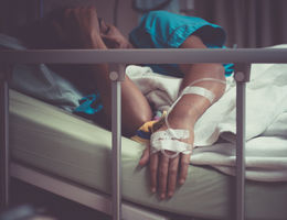 sick woman lying in hospital bed 