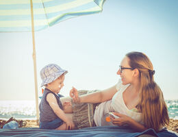 Family applying sunscreen at beach