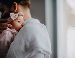 father holding infant baby