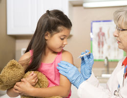 Young Hispanic girl gets a flu shot