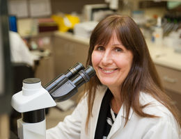 White female physician in a medical lab. 