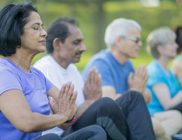 group of people doing a namaste pose