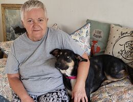 Minerva Catinean embraces her dog, Bella