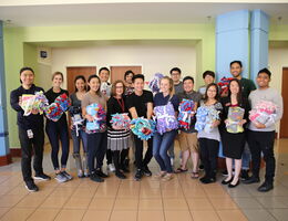 Group of people in a lobby holding gift blankets