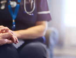 nurse holding patient's hand