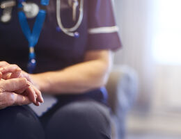 nurse holding patient's hand