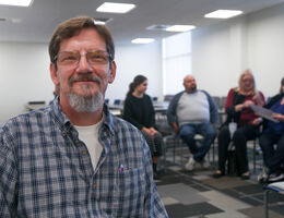 man with a support group behind him