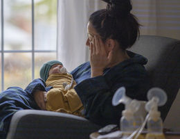 mother holding baby on rocking chair