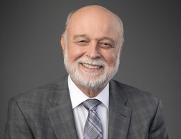 Man smiles in formal portrait