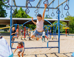 Kids playing on a playground during summer