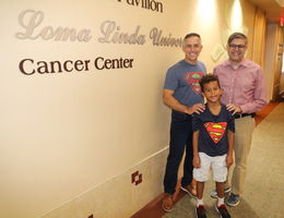 cancer survivor, student and doctor stand together