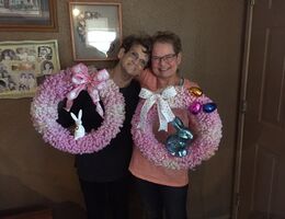 Two women holding easter wreaths