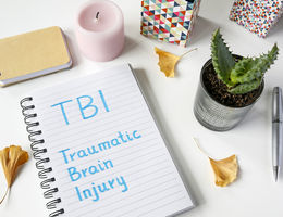 note book that has traumatic brain injury written