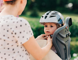 baby safely fastened into baby seat