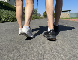two people walking on concrete 
